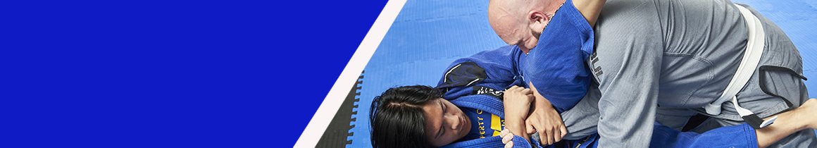 Two competitors practicing their Muay Thai skills on blue and black foam tatami flooring mats