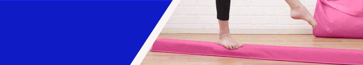 Person walks across pink balance beam