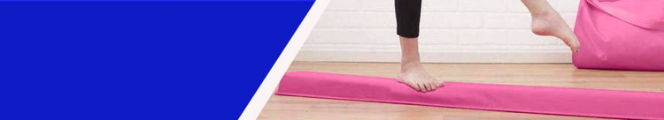 Person walks across pink balance beam
