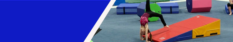  Girl doing flip in gym with tumbling mats and cheese wedge incline mats